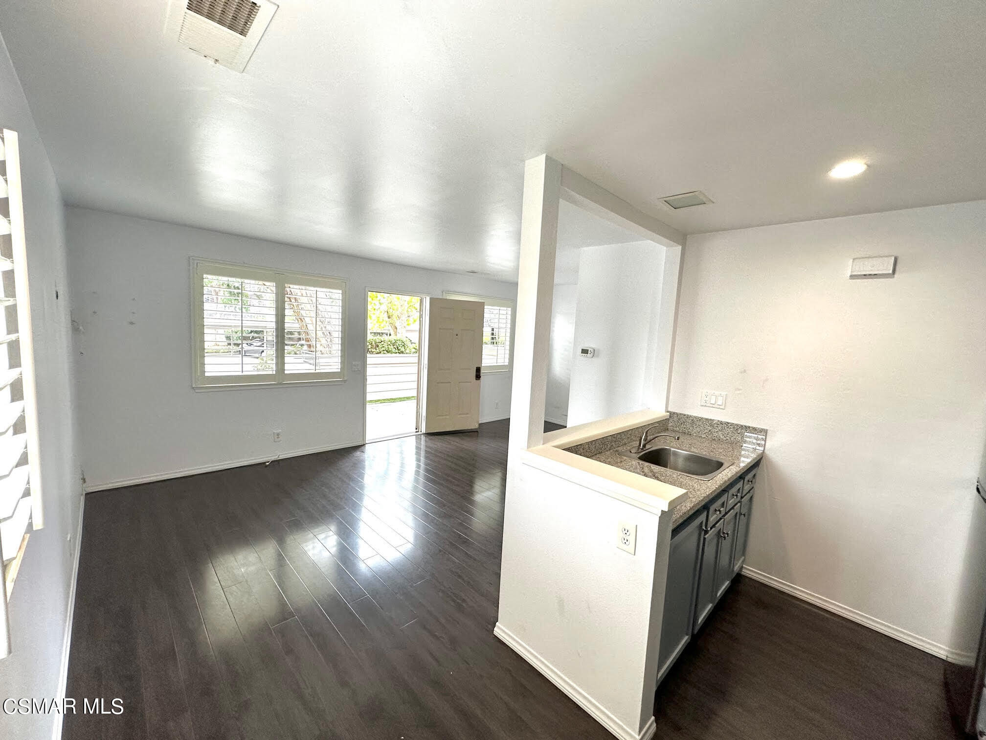 4541 Alamo Street, Unit A Simi Valley, CA 93063 - Photo 18 of 20 a kitchen with granite countertop a stove and a wooden floors