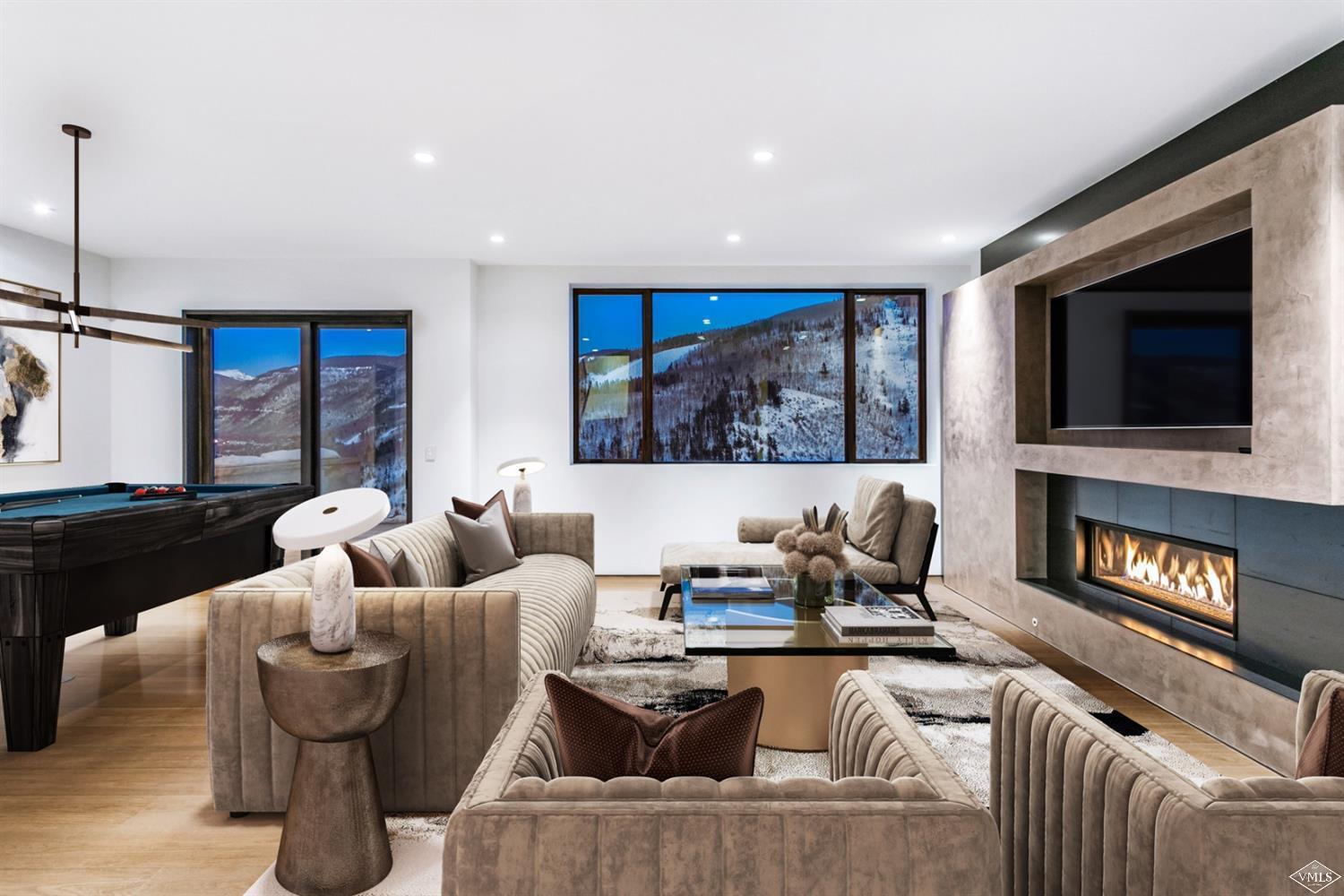 1450 Buffehr Creek Road Vail, CO 81657 - Photo 11 of 16 a living room with fireplace furniture and a flat screen tv