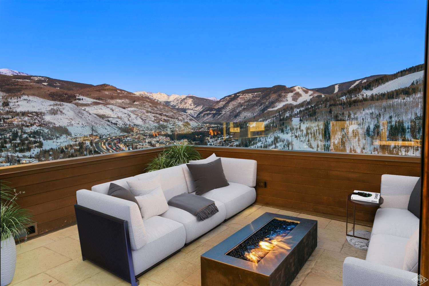 1450 Buffehr Creek Road Vail, CO 81657 - Photo 3 of 16 a view of a couch in the roof deck with couple of tennis court