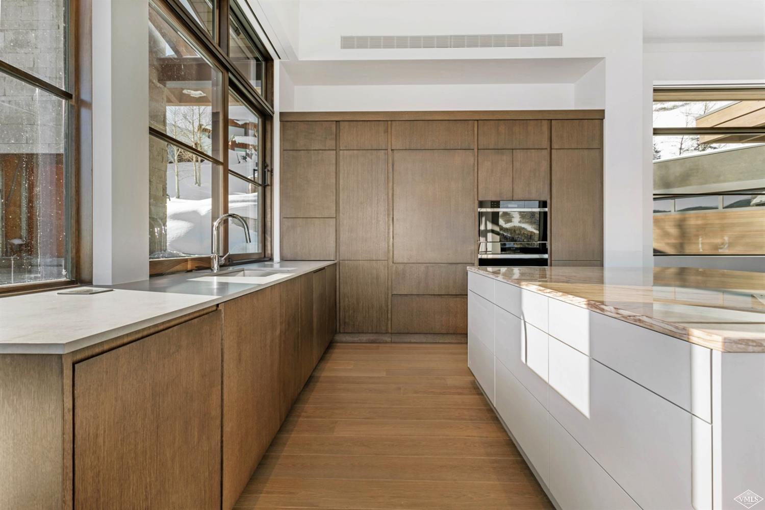 1450 Buffehr Creek Road Vail, CO 81657 - Photo 5 of 16 a kitchen with stainless steel appliances a sink stove and cabinets