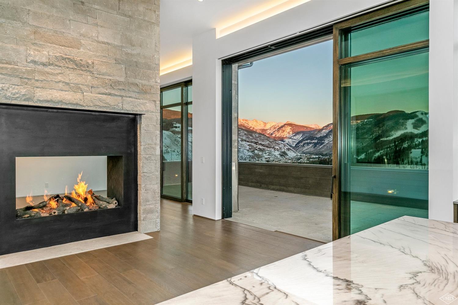 1450 Buffehr Creek Road Vail, CO 81657 - Photo 6 of 16 a view of a floor to ceiling window and a fireplace
