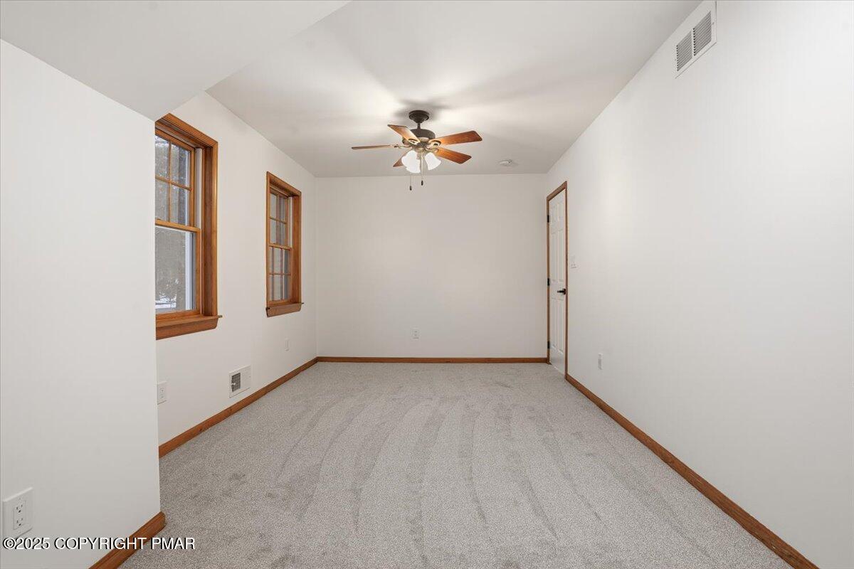 1395 Kelly Road Stroudsburg, PA 18360 - Photo 38 of 48 an empty room with chandelier fan and windows