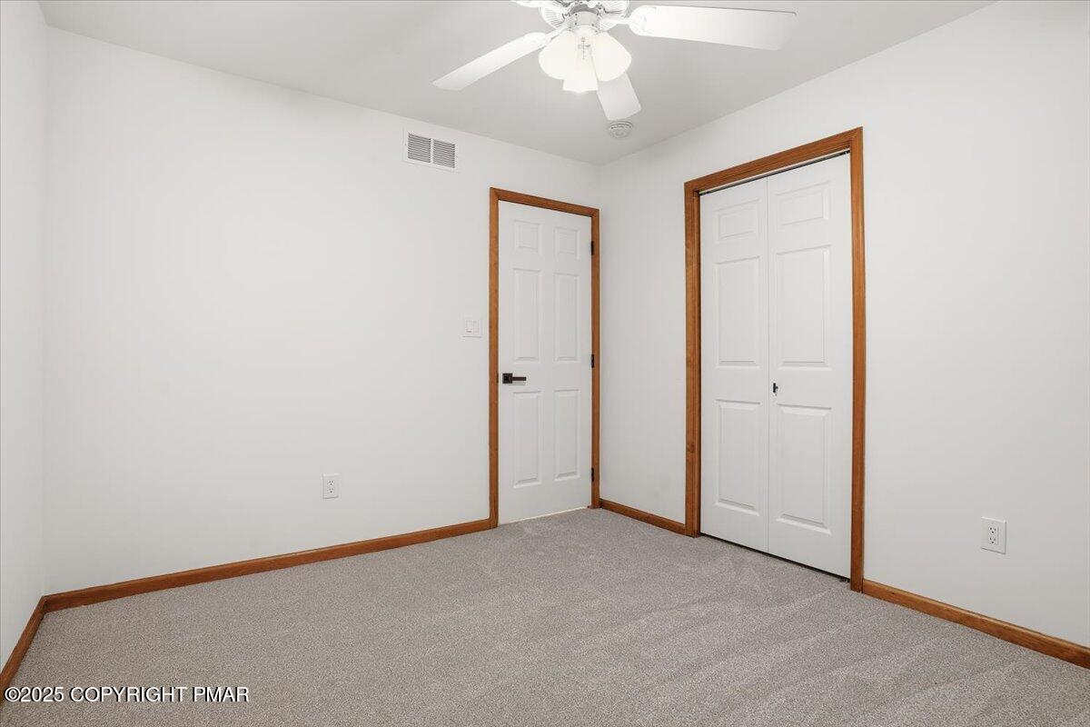 1395 Kelly Road Stroudsburg, PA 18360 - Photo 40 of 48 an empty room with a ceiling fan and a window