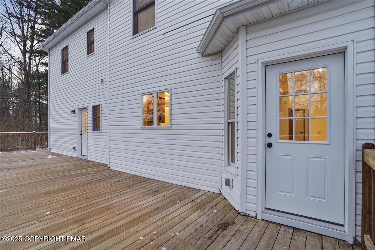 1395 Kelly Road Stroudsburg, PA 18360 - Photo 8 of 48 a view of a house with a wooden deck