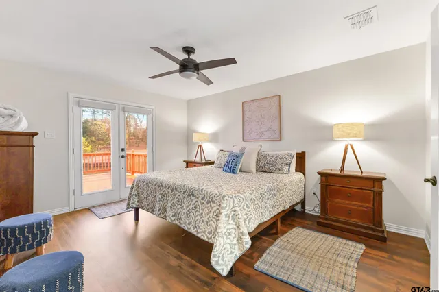 a spacious bedroom with a large bed and a chandelier