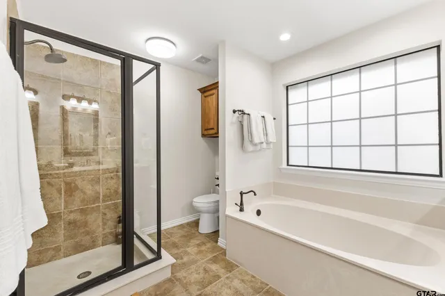 a bathroom with a bathtub and a shower