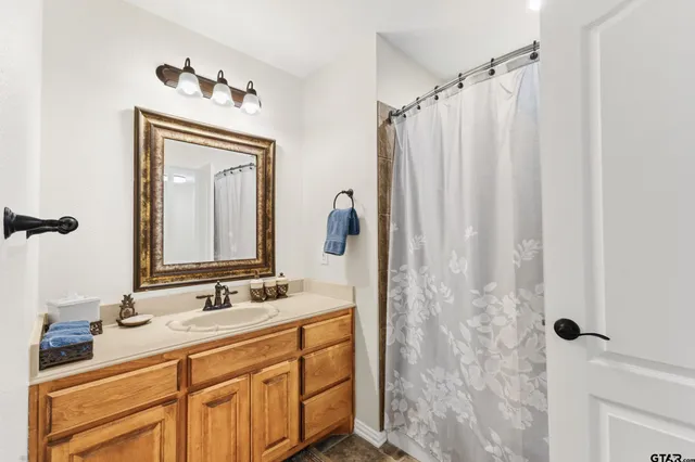 a bathroom with a double vanity sink and mirror