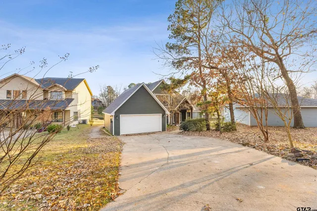 a view of a house with a yard covered in snow