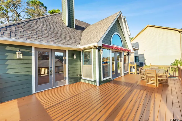 a view of backyard with a deck and wooden floor
