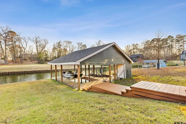 a view of a house with yard and sitting area