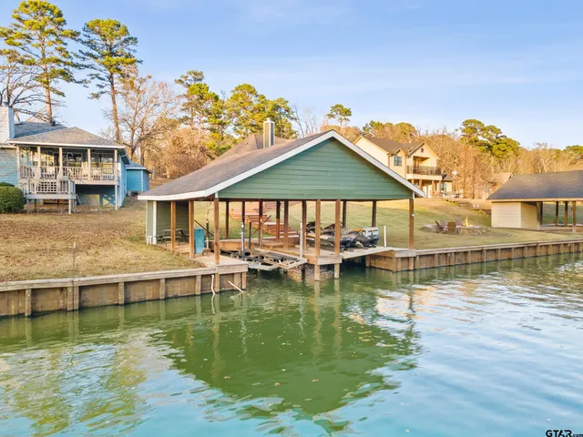 a swimming pool view with a seating space and a garden view