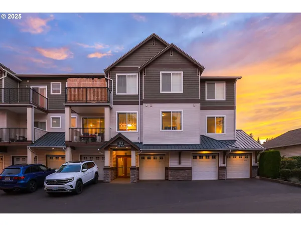 a front view of a residential apartment building with a yard