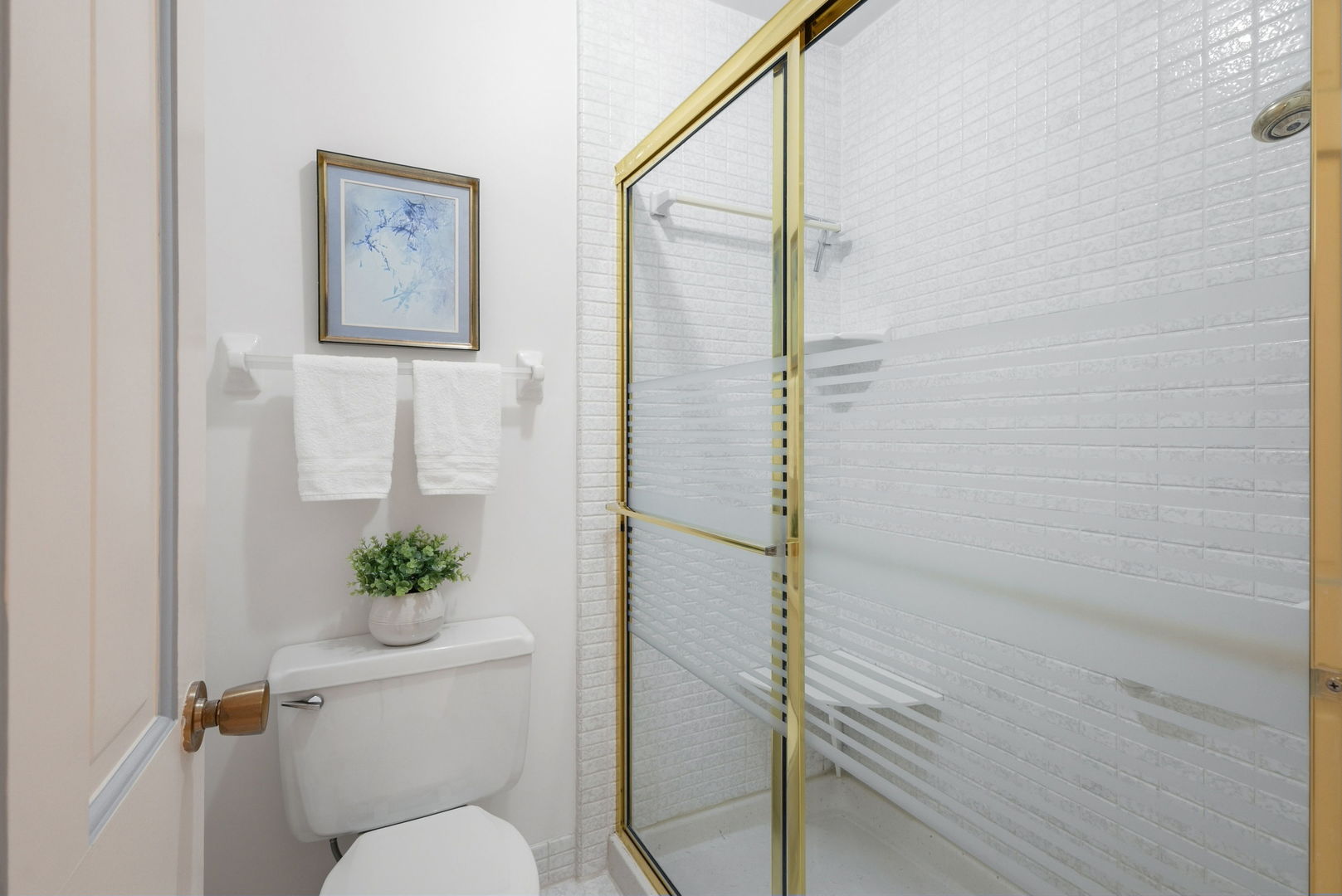 715 Tomlin Drive, Unit A1 Burr Ridge, IL 60527 - Photo 18 of 24 a bathroom with a toilet and a shower