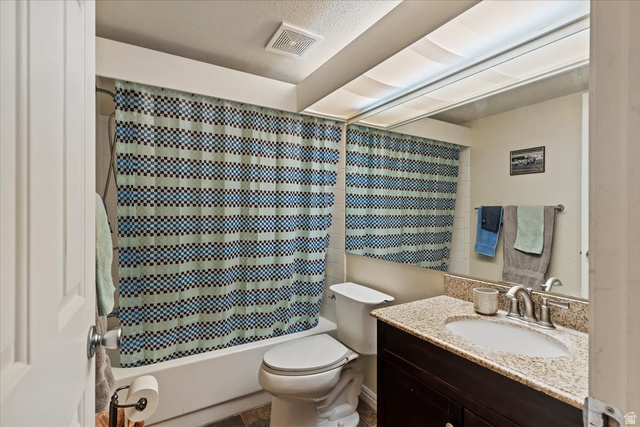 650 South Main Street, Unit 4104 Bountiful, UT 84010 - Photo 12 of 22 Full bathroom with vanity, shower / bath combo, and a textured ceiling