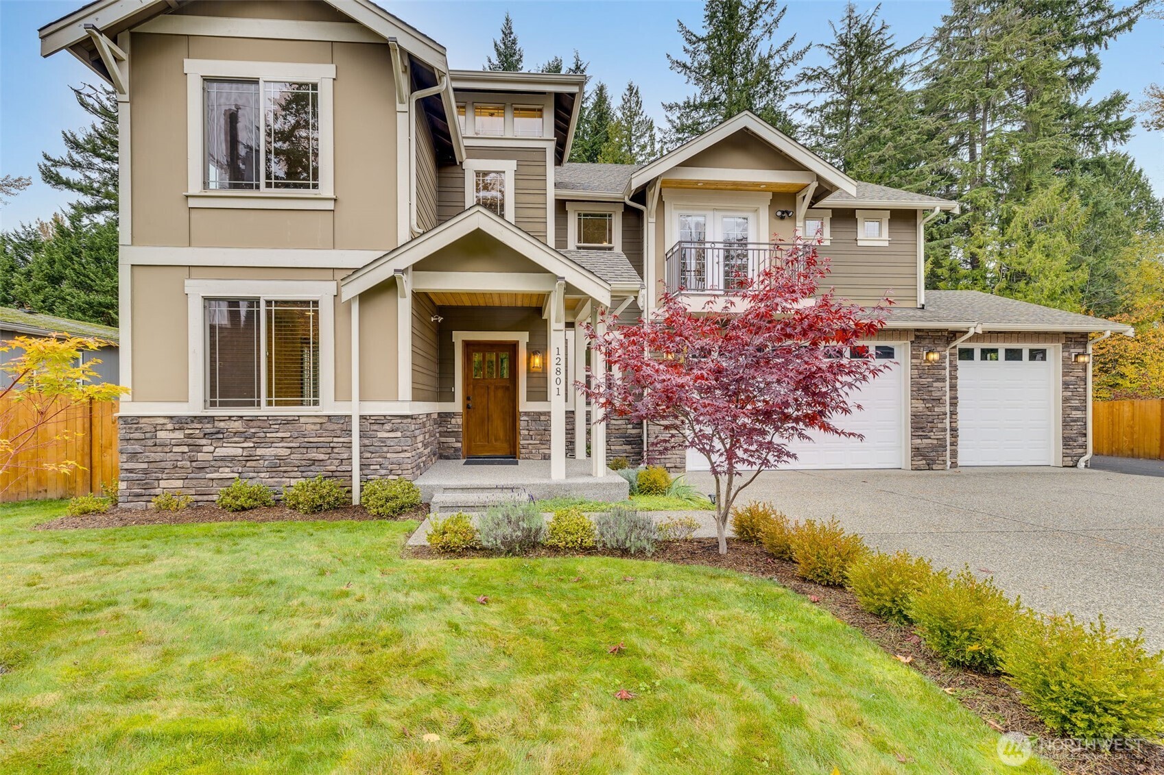 12801 218th Place Southeast Snohomish, WA 98296 - Photo 2 of 38 a front view of a house with a yard and garage