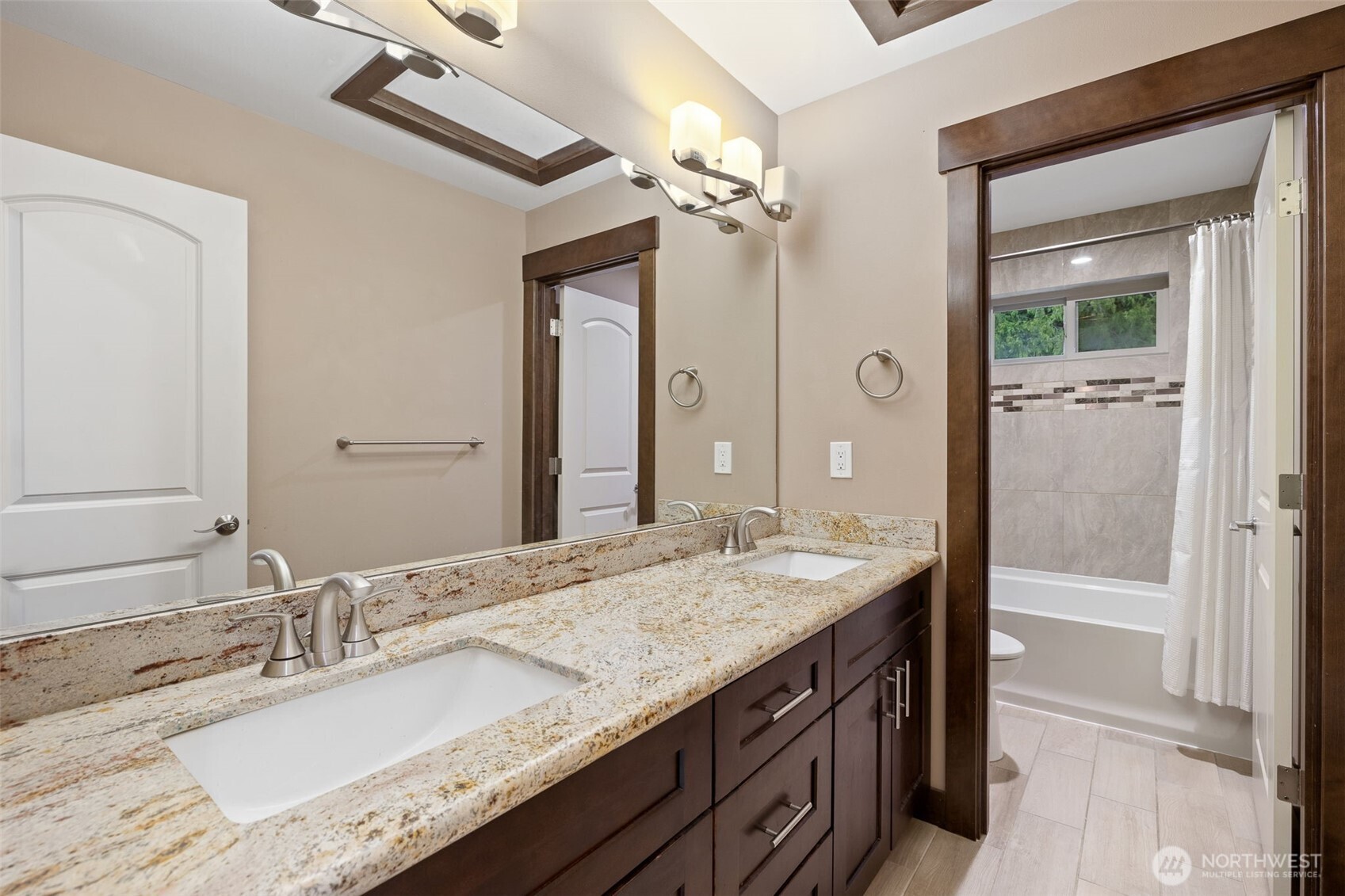 12801 218th Place Southeast Snohomish, WA 98296 - Photo 26 of 38 a bathroom with a granite countertop sink double vanity and a mirror