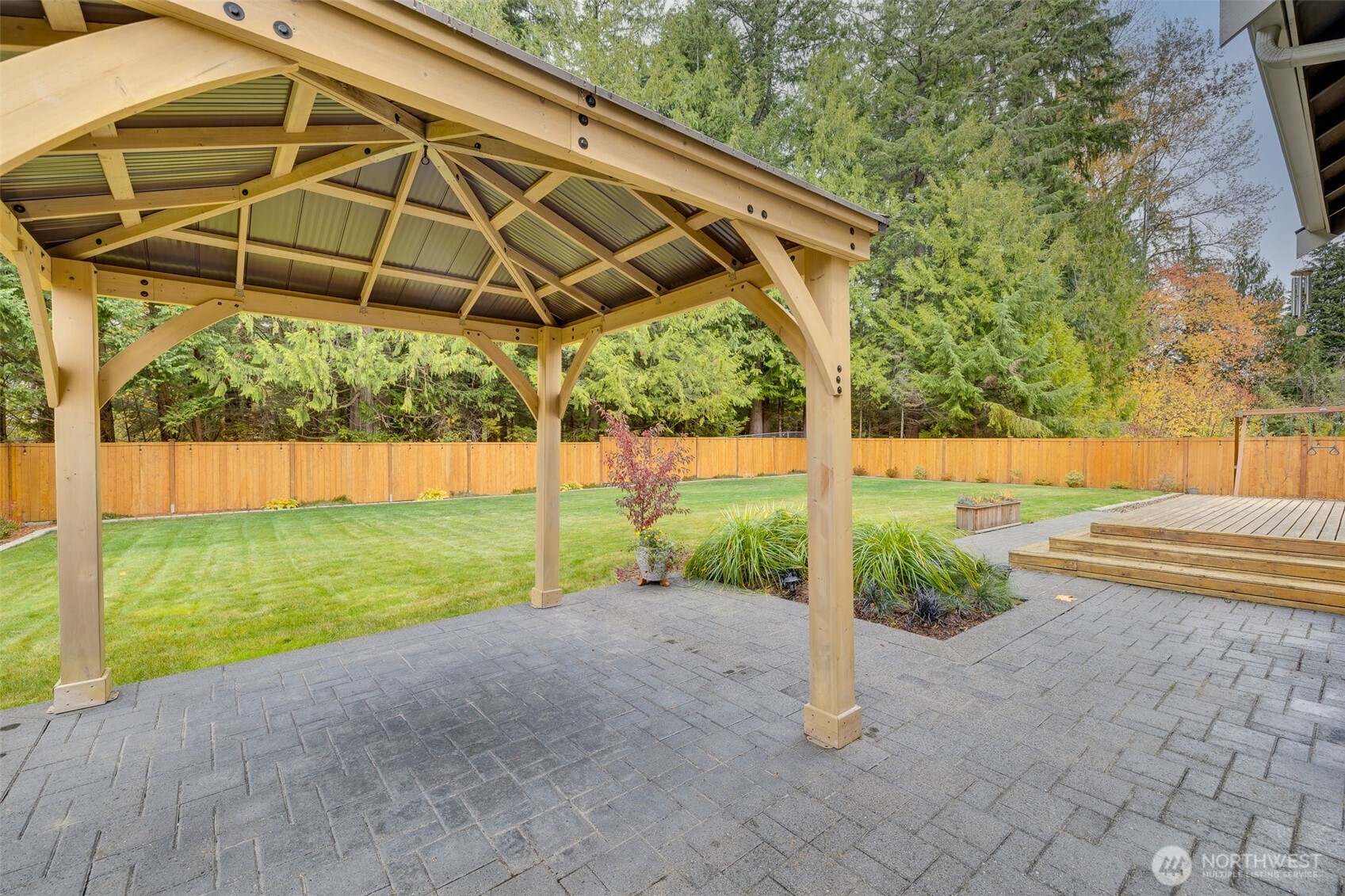 12801 218th Place Southeast Snohomish, WA 98296 - Photo 31 of 38 a view of a backyard with table and chairs under an umbrella