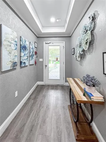 a view of a livingroom with furniture wooden floor and a large window