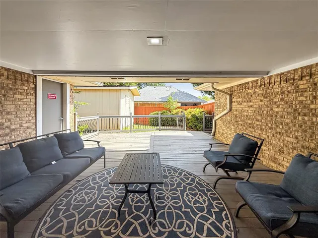 a balcony with furniture and a potted plant