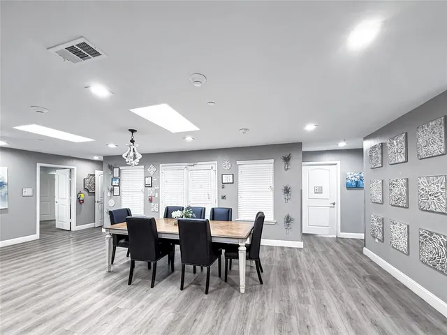 a view of a hallway with workspace and mirrors