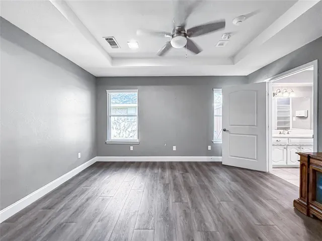 a spacious bathroom with a sink and a large mirror