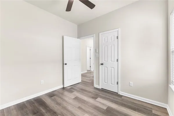 an empty room with windows and closet