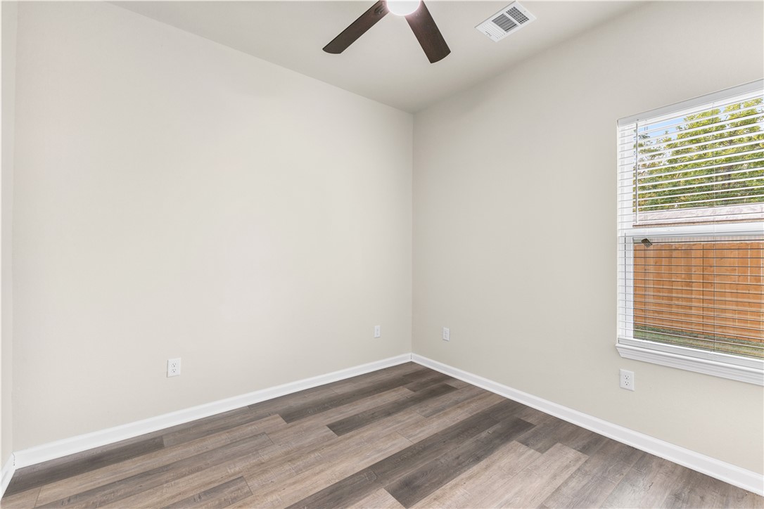 1601 West 17th Street Bryan, TX 77803 - Photo 14 of 16 an empty room with a window and a ceiling fan