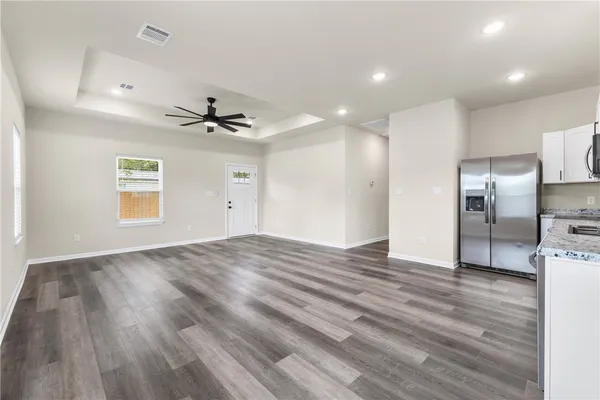 a view of a kitchen with a sink and a refrigerator
