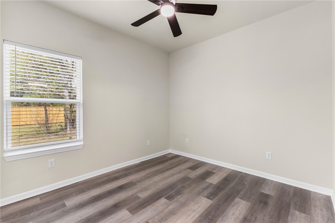 1601 West 17th Street Bryan, TX 77803 - Photo 9 of 16 an empty room with a window and a ceiling fan