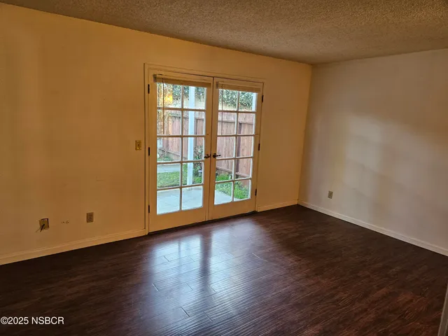 a view of a room with wooden floor and window