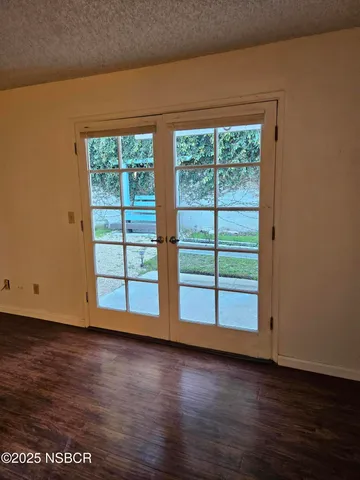 a view of a room with wooden floor and window