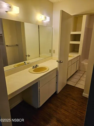 a bathroom with a sink a mirror and a shower