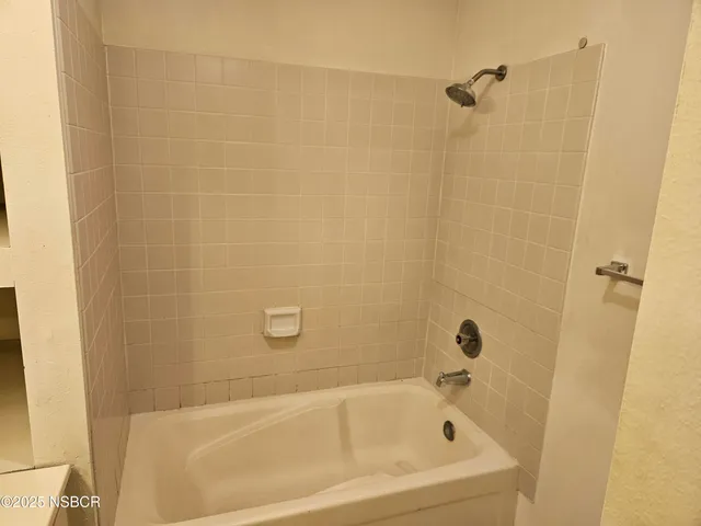 a white bath tub and a shower