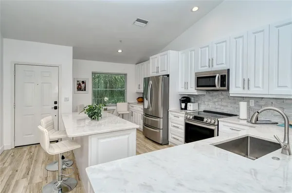 a kitchen with a sink stove and refrigerator