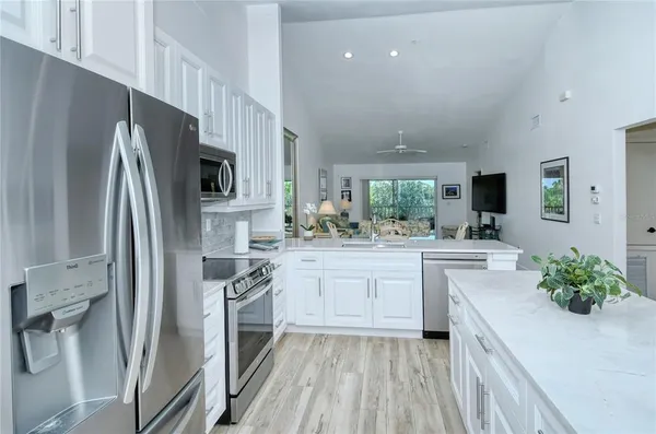 a kitchen with white cabinets and stainless steel appliances