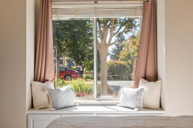 a white vase sitting on a table and window