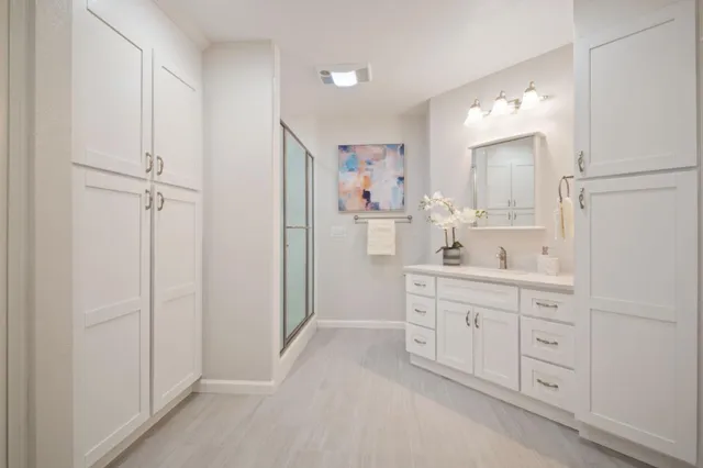 a spacious bathroom with a double vanity sink a mirror and a bathtub