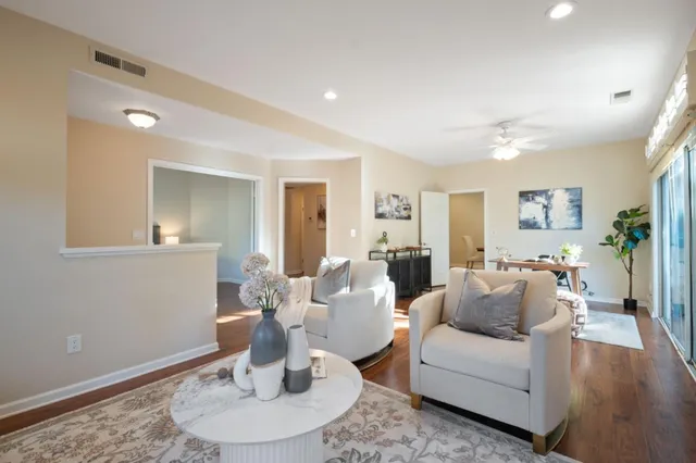 a living room with furniture and a wooden floor