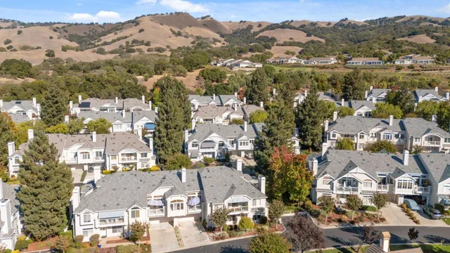 an aerial view of residential houses with outdoor space