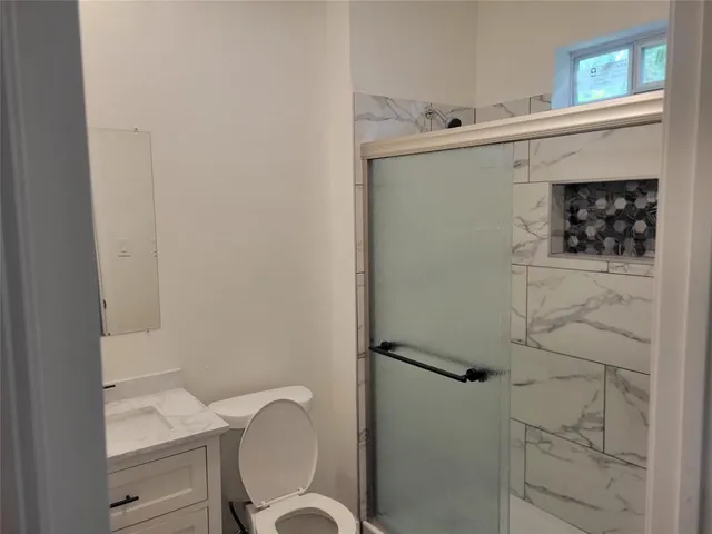 a bathroom with a toilet sink and shower