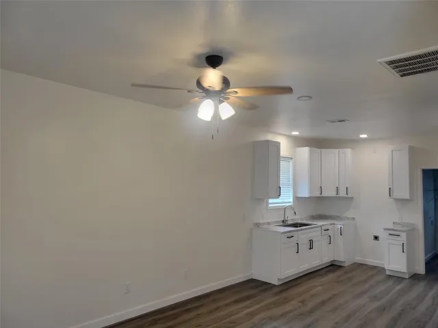 a kitchen with a refrigerator and a stove top oven