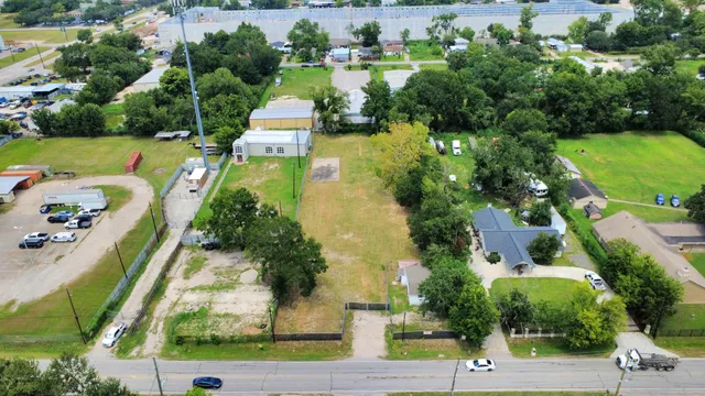an aerial view of a house with a yard basket ball court and outdoor seating