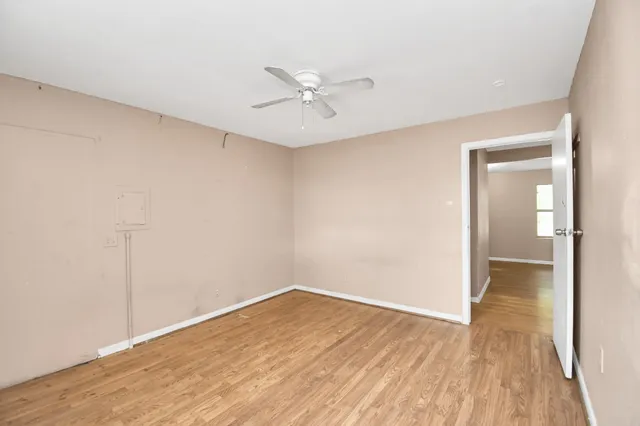 wooden floor in an empty room with a window