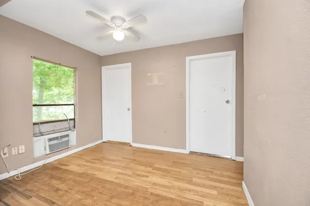 a view of a room with a ceiling fan and a window