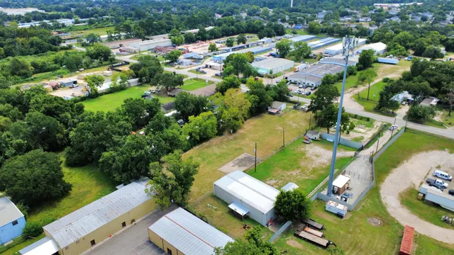 an aerial view of residential houses with outdoor space and swimming pool