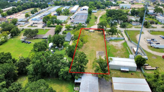 an aerial view of residential houses with outdoor space and swimming pool