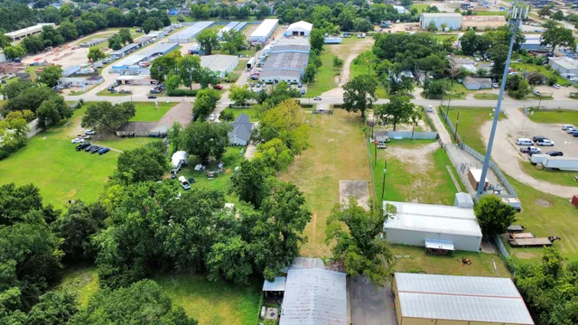 an aerial view of residential houses with outdoor space and swimming pool