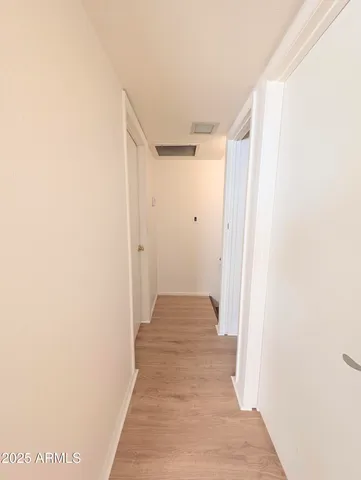 a view of a hallway with wooden floor
