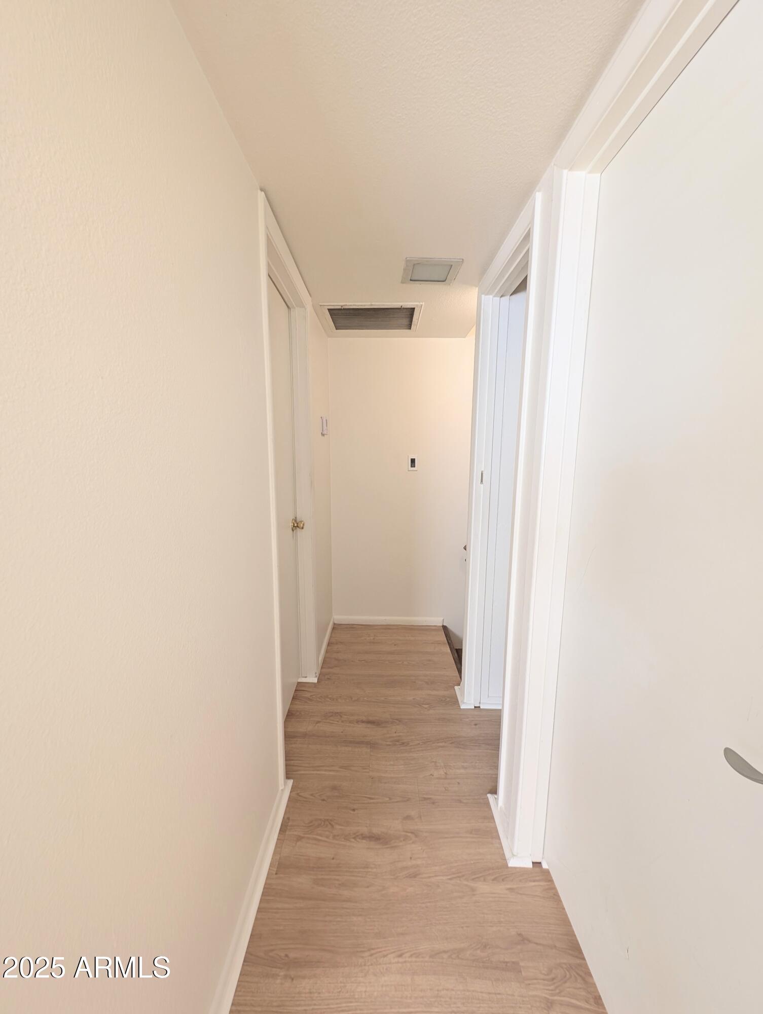 Undisclosed Address Chandler, AZ 85225 - Photo 12 of 21 a view of a hallway with wooden floor
