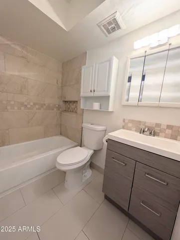 a bathroom with a sink a toilet and a bathtub